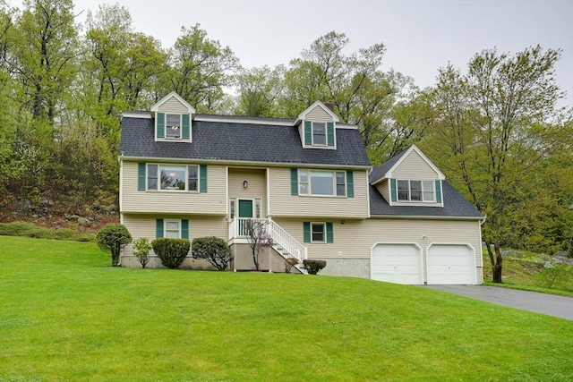5 Rollie Shepard Dr, Millbury, MA 01527 - split foyer home with asphalt driveway, a front yard, and view of wooded area