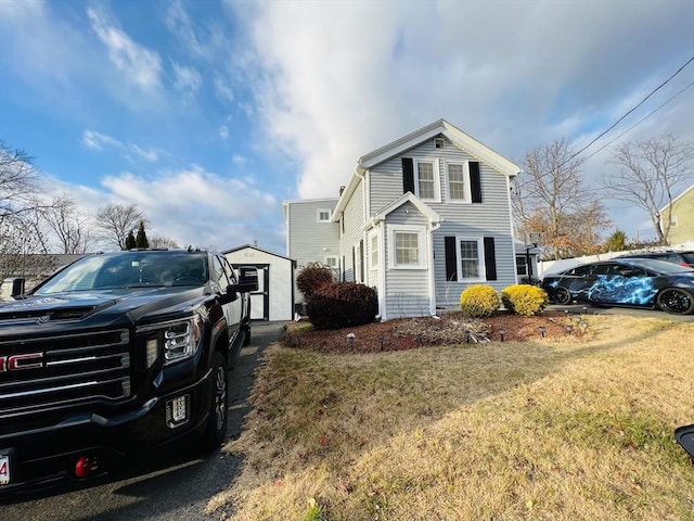 view of home's exterior featuring a yard and a storage unit