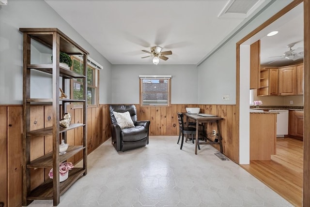 30 Edge Hill Rd, Lynn, MA 01904 - living area featuring a ceiling fan, wainscoting, wooden walls, and light floors