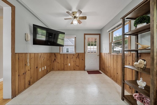 30 Edge Hill Rd, Lynn, MA 01904 - doorway featuring wainscoting, wood walls, a ceiling fan, and tile patterned floors