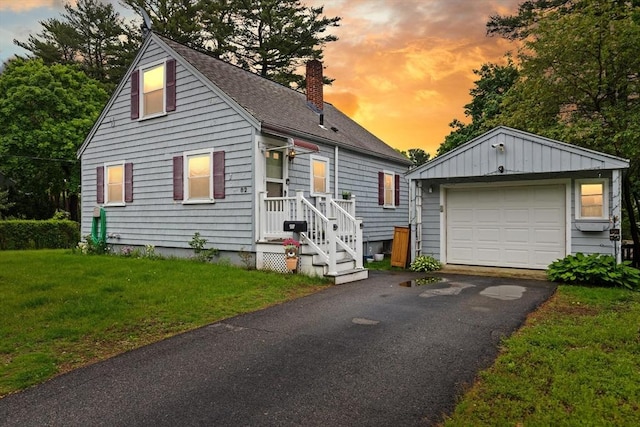 82 Brickel Rd, Stoughton, MA 02072 - view of front of house with a chimney, an outbuilding, a detached garage, a shingled roof, and a front yard