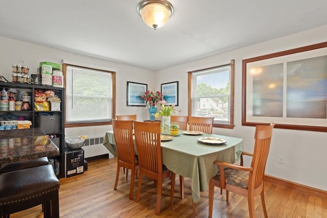 82 Brickel Rd, Stoughton, MA 02072 - dining area featuring plenty of natural light, hardwood / wood-style floors, baseboards, and radiator heating unit