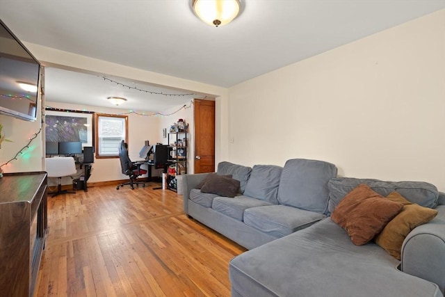 82 Brickel Rd, Stoughton, MA 02072 - living room with a desk, light wood-style floors, and baseboards