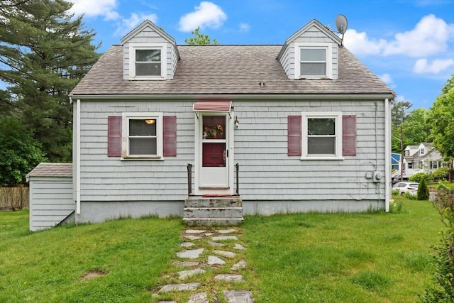 82 Brickel Rd, Stoughton, MA 02072 - new england style home with a front yard, a shingled roof, and entry steps