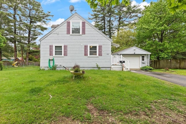 82 Brickel Rd, Stoughton, MA 02072 - rear view of house featuring a detached garage, driveway, and an outbuilding