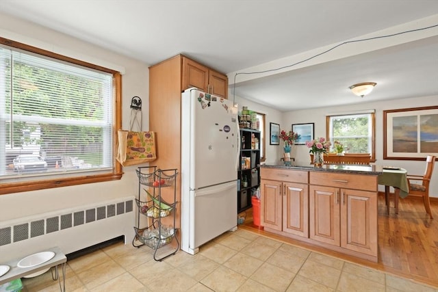 82 Brickel Rd, Stoughton, MA 02072 - kitchen featuring freestanding refrigerator, radiator heating unit, and a center island