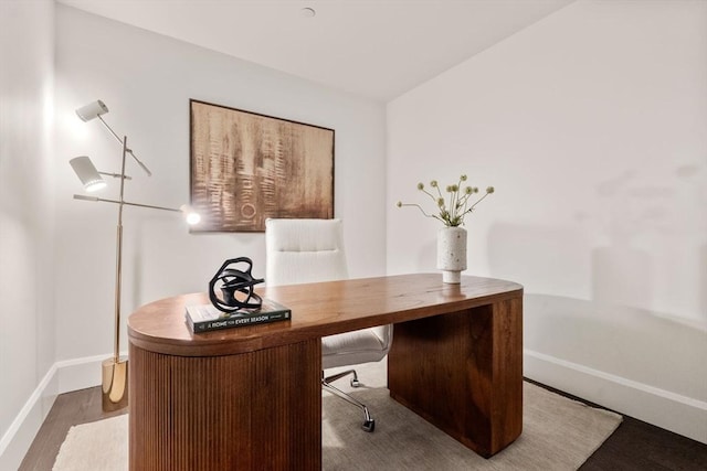 office area featuring baseboards and wood finished floors