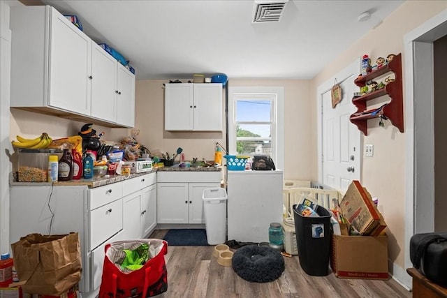 39 Worcester St, Southbridge, MA 01550 - kitchen featuring dark wood-style floors, white cabinets, a sink, and light countertops