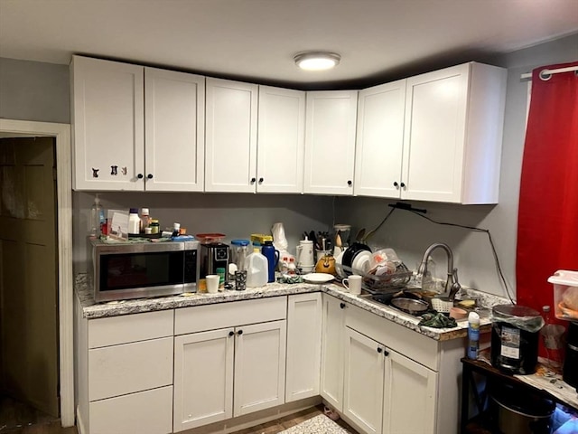 39 Worcester St, Southbridge, MA 01550 - kitchen with stainless steel microwave, a sink, and white cabinets