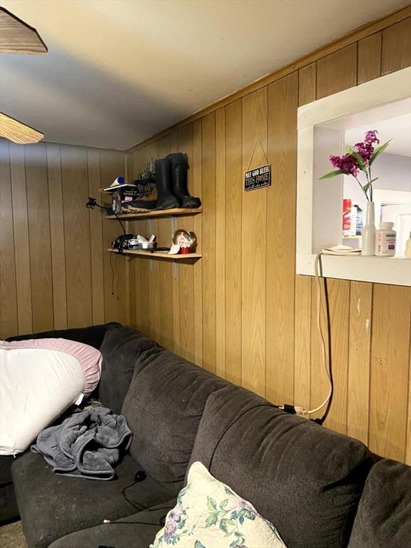 39 Worcester St, Southbridge, MA 01550 - living area with wooden walls and ceiling fan