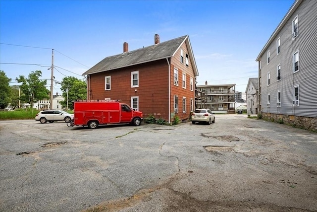 39 Worcester St, Southbridge, MA 01550 - view of property exterior featuring uncovered parking and a chimney