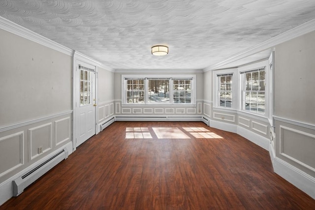 spare room with baseboard heating, a textured ceiling, and wood finished floors