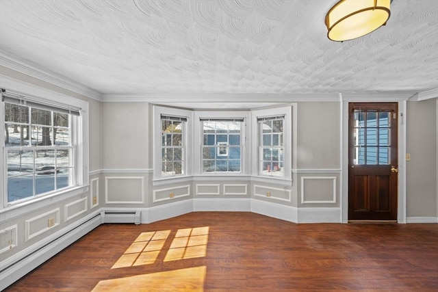 foyer entrance with crown molding, wood finished floors, baseboard heating, and a textured ceiling