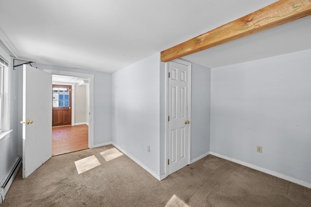 empty room with beam ceiling, baseboards, carpet floors, and a baseboard radiator