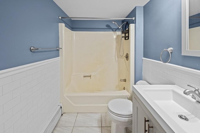 bathroom featuring tile patterned flooring, tile walls, and wainscoting