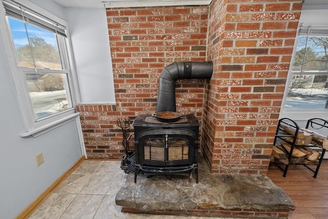 room details featuring a wood stove and baseboards