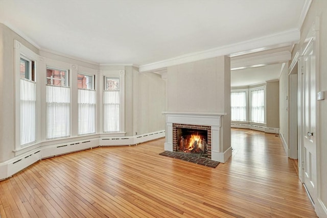 unfurnished living room featuring a fireplace, light hardwood / wood-style floors, baseboard heating, and ornamental molding