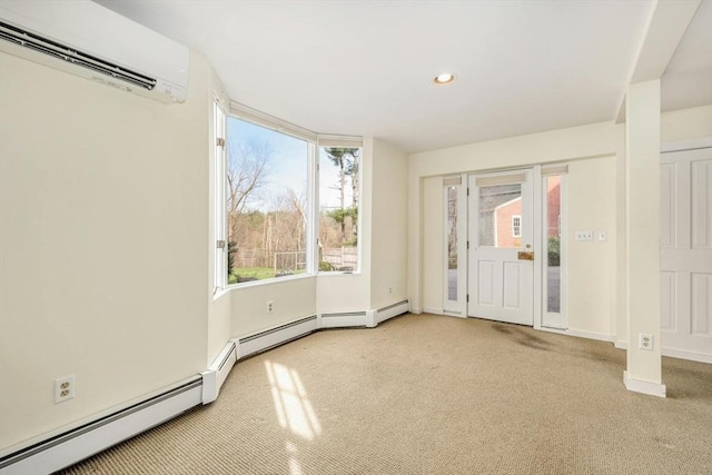 interior space featuring light colored carpet, baseboard heating, a wall mounted AC, and a healthy amount of sunlight