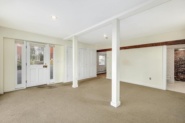 entrance foyer with carpet flooring and a baseboard heating unit