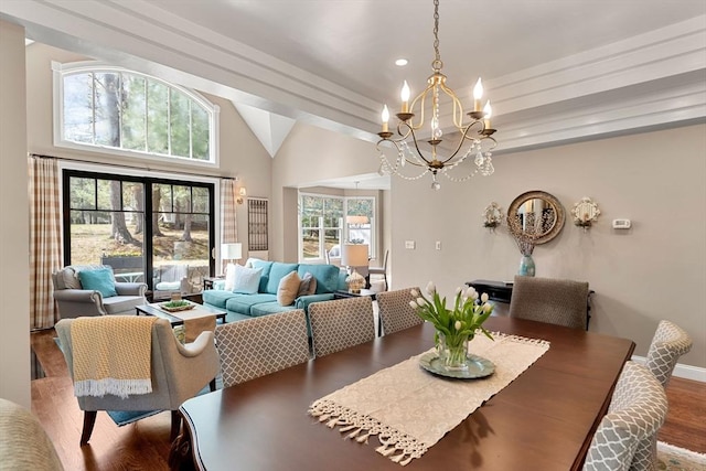 dining space featuring wood finished floors, baseboards, recessed lighting, a chandelier, and vaulted ceiling