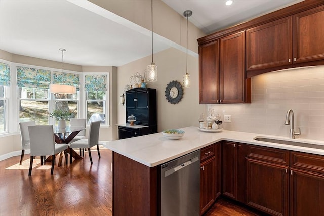 kitchen featuring a sink, plenty of natural light, tasteful backsplash, and dishwasher