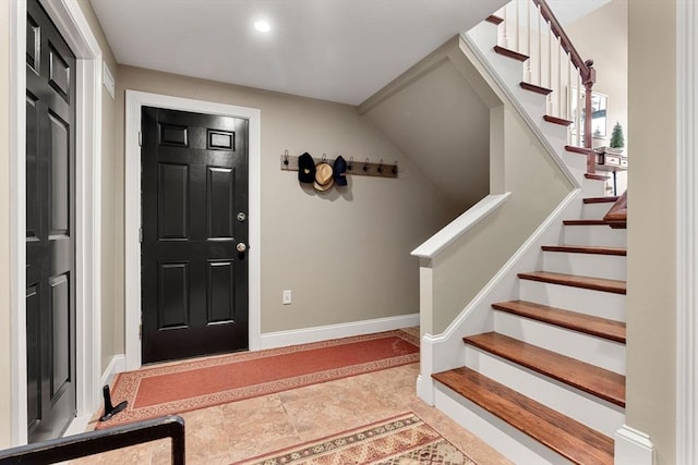 entrance foyer with recessed lighting, baseboards, and stairway
