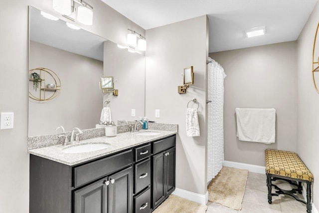 bathroom featuring walk in shower, vanity, and tile patterned flooring