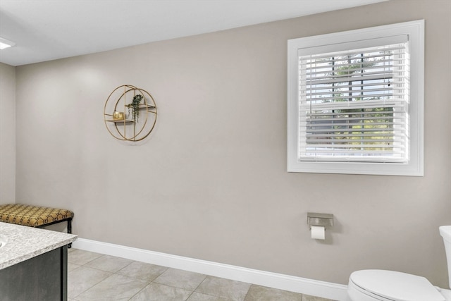 bathroom featuring tile patterned flooring, vanity, and toilet