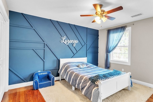 bedroom with wood-type flooring and ceiling fan