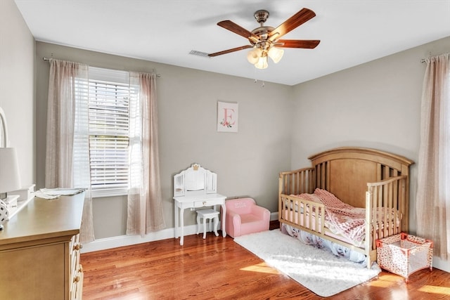 bedroom featuring light wood-type flooring and ceiling fan