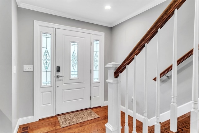 entrance foyer featuring light hardwood / wood-style flooring and crown molding