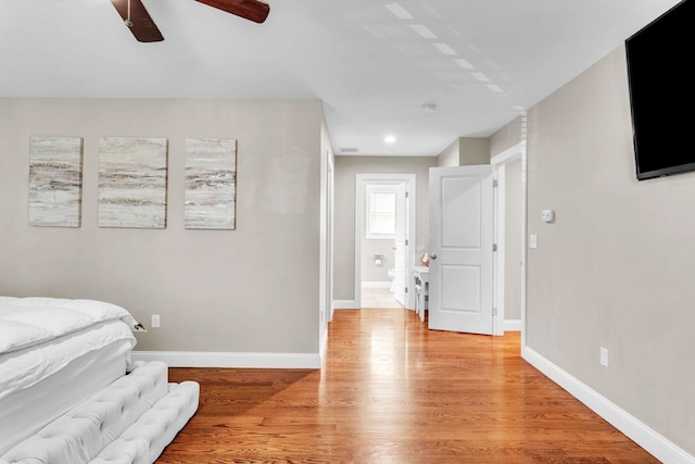 bedroom with light hardwood / wood-style flooring and ceiling fan