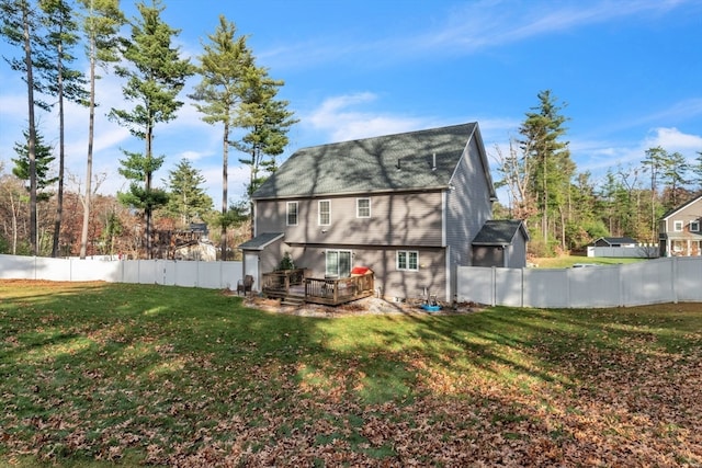 back of property featuring a wooden deck and a lawn