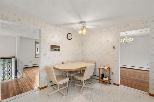 dining area with a baseboard radiator, wallpapered walls, a chandelier, ceiling fan, and baseboards