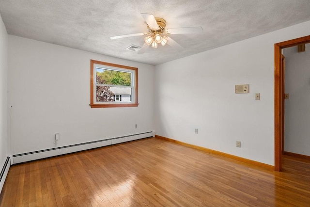 unfurnished room featuring a baseboard heating unit, ceiling fan, light wood-style floors, and baseboards