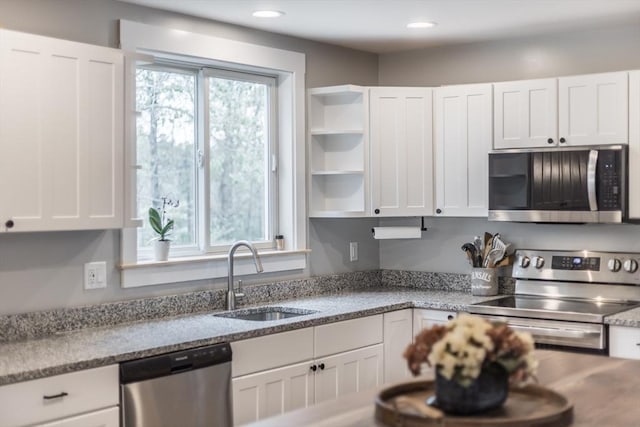 115 Kiahs Way, Sandwich, MA 02537 - kitchen with appliances with stainless steel finishes, a sink, white cabinets, open shelves, and light stone countertops