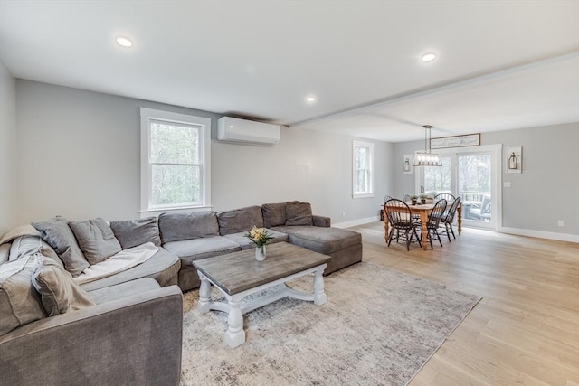 115 Kiahs Way, Sandwich, MA 02537 - living room featuring an AC wall unit, baseboards, light wood-style floors, and recessed lighting