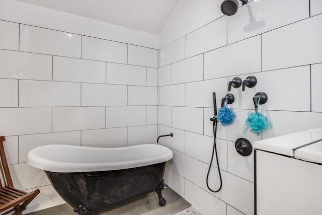 115 Kiahs Way, Sandwich, MA 02537 - bathroom featuring tile walls, a soaking tub, and lofted ceiling