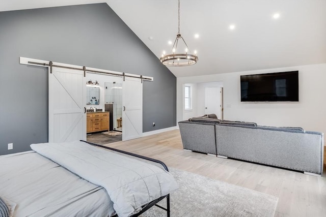 115 Kiahs Way, Sandwich, MA 02537 - bedroom with a barn door, high vaulted ceiling, a chandelier, light wood finished floors, and baseboards