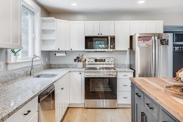 115 Kiahs Way, Sandwich, MA 02537 - kitchen featuring appliances with stainless steel finishes, a sink, white cabinetry, light stone countertops, and recessed lighting