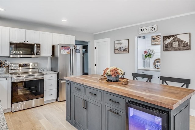 115 Kiahs Way, Sandwich, MA 02537 - kitchen with stainless steel appliances, butcher block countertops, wine cooler, light wood finished floors, and white cabinets