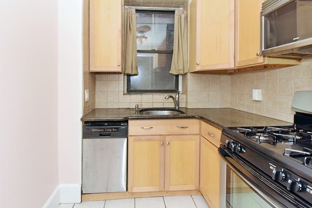 kitchen with appliances with stainless steel finishes, backsplash, sink, and light brown cabinetry