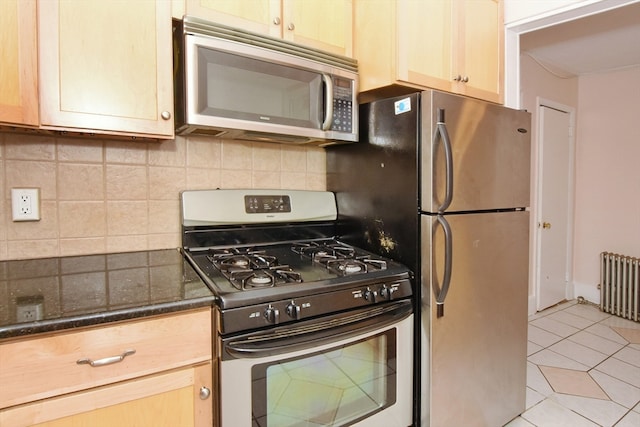 kitchen featuring decorative backsplash, appliances with stainless steel finishes, light tile patterned flooring, and light brown cabinetry