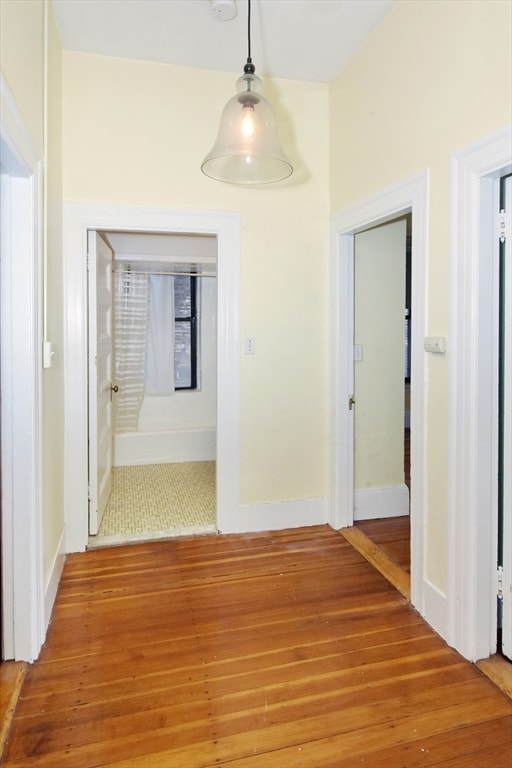 hallway with tile patterned floors