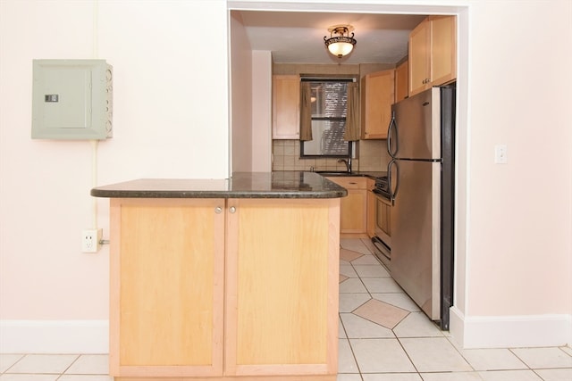 kitchen with light tile patterned floors, backsplash, electric panel, kitchen peninsula, and stainless steel refrigerator