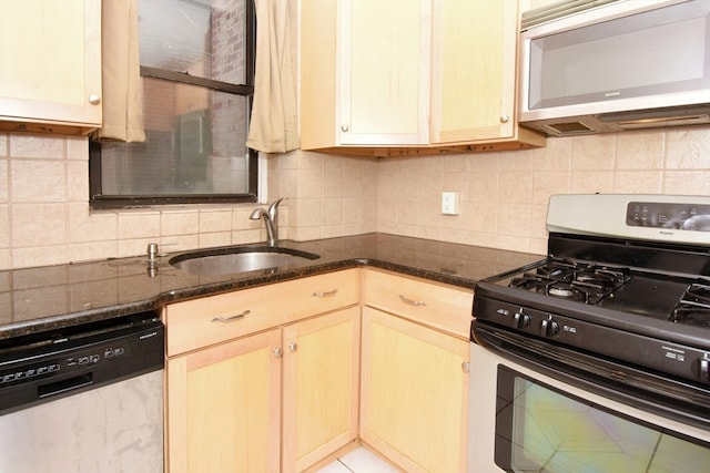 kitchen with tasteful backsplash, sink, dishwasher, and stainless steel gas range oven