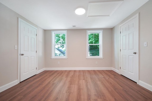 41 Adams St, Fairhaven, MA 02719 - unfurnished bedroom featuring wood finished floors and attic access