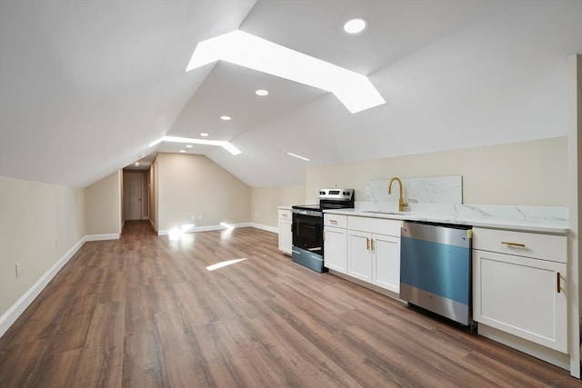 41 Adams St, Fairhaven, MA 02719 - kitchen featuring stainless steel appliances, a skylight, wood finished floors, white cabinetry, and light stone countertops