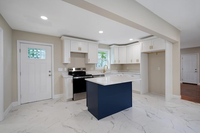 41 Adams St, Fairhaven, MA 02719 - kitchen featuring stainless steel appliances, white cabinets, a center island, recessed lighting, and light marble finish floors