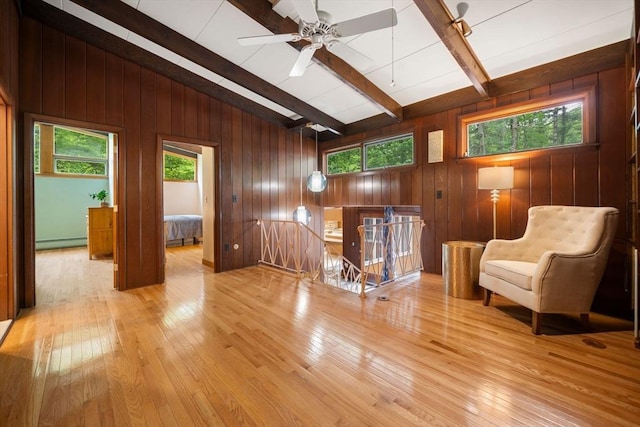 181 Thayer Farms Rd, Attleboro, MA 02703 - sitting room with an upstairs landing, a baseboard heating unit, wood-type flooring, wooden walls, and a ceiling fan